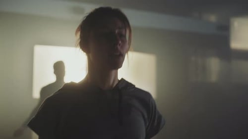 Woman Does Cardio in Smoky Workout Room