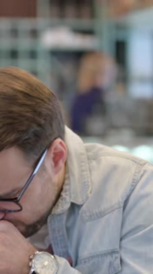 Adult Man Coughing Indoors with Glasses in Portrait