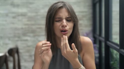 Young Woman Getting Tooth Pain During Meal in Cafe 30s