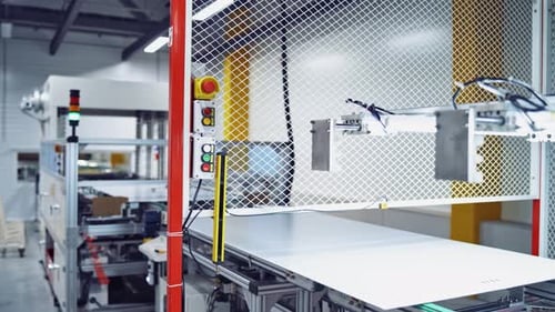 Modern factory background. Worker controls the work on a conveyor during making new details.