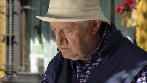 Senior Man Playing Chess in the Garden