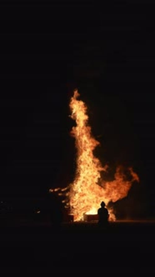 Large Fire Burning at Night with Observers in Black Rock City Nevada