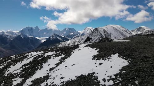 Snowy Mountain Landscape with Horse and Rider
