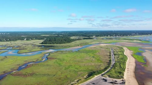 Cape Cod Aerial Drone Footage of Marsh and Beach at Low Tide with People and Tall Green Grass