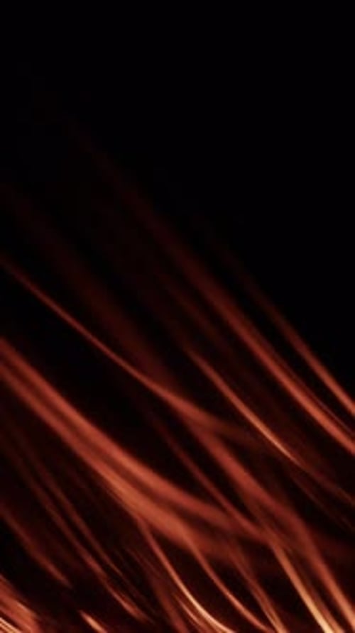 Fire Light Streaks In Smooth Motion Against Darkness