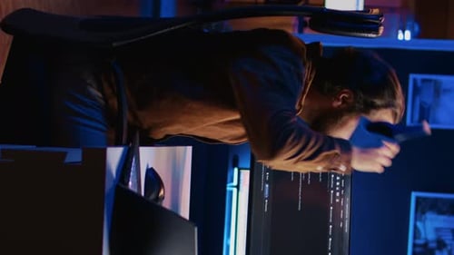 Software Technician Typing Code in Neon Lit Personal Office