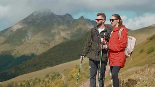 Couple Hiking in the Mountains on Sunny Day