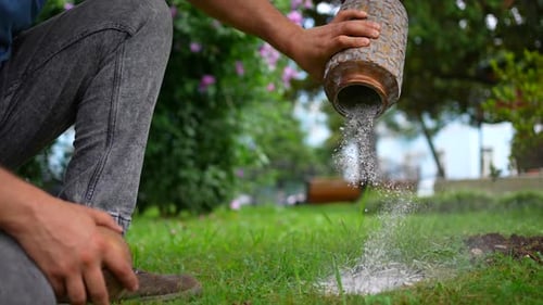 Scattering of Ashes After Cremation in the Park Into the Ground