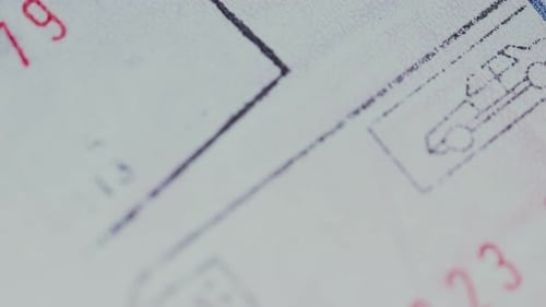 Passport Stamps and Travel Visas Close-up - International Border Crossing Concept