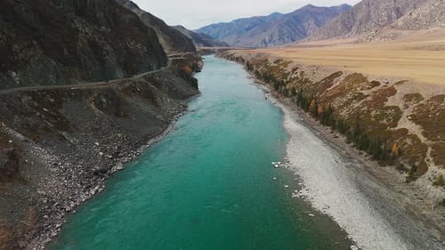 Stunning River Flows Through Mountains in Remote Wilderness During Autumn