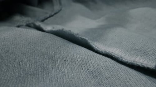 Macro Shot of Light Blue Textured Fabric and Seam