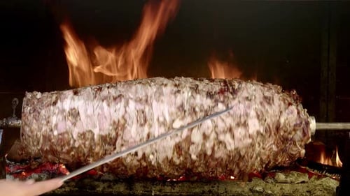 Meat Cooking on Spit with Flames