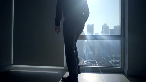 Young Successful Man Living in High Rise City Apartment With Skyline View