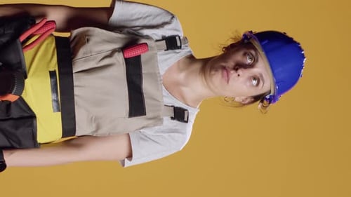 Vertical Video Portrait of Female Builder Being Hit in Head and Feeling Dizzy
