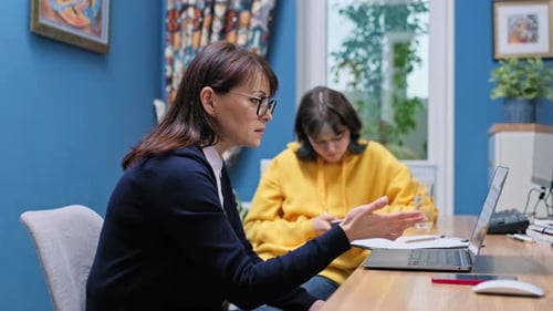 Teenage Girl College Student Talking with Counselor Psychologist in Office
