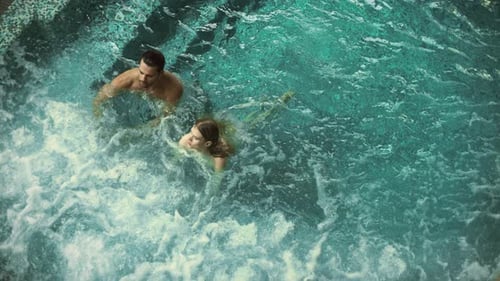 Above View of Attractive Couple Relaxing in Whirlpool Bath Together. Lovely Couple