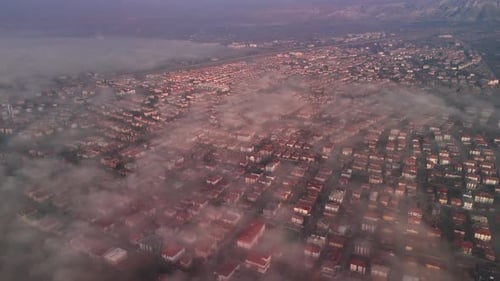 the view of the clouds over the city from the air