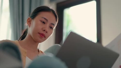 Young Woman Works on Laptop in Bright Home