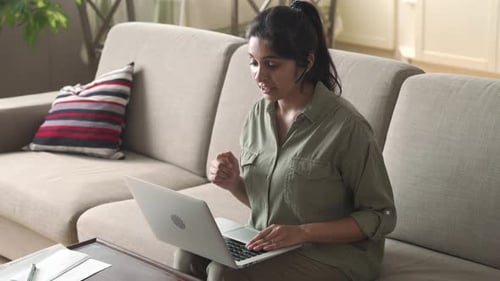 Indian woman teacher conducts virtual business conference from home office