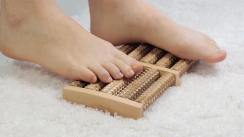 Feet Rolling on Wooden Foot Massage Tool