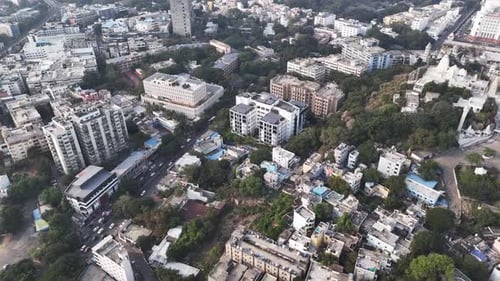 Cinematic aerial view of Hyderabad showcasing dense residential blocks, tree-lined streets, and