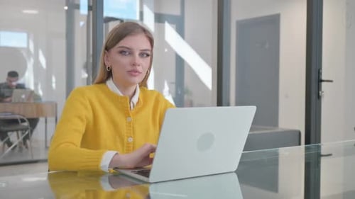 Woman Working on Laptop in Modern Office