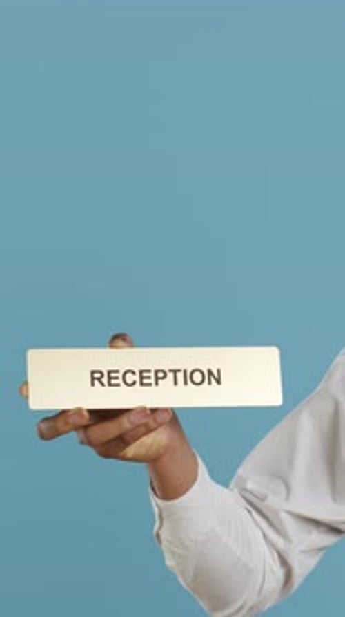Vertical Video Hotel Concierge Staff Showing the Reception Indicator at Front Desk