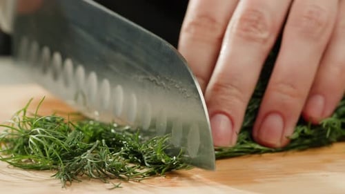 Cutting Dill Chef Cut Dill with Knife on a Wooden Board Close Up at Home Vitamin Vegan Greens