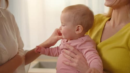 Adults Interacting with Baby Indoors