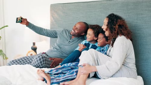Happy Family Taking Selfie on Bed at Home