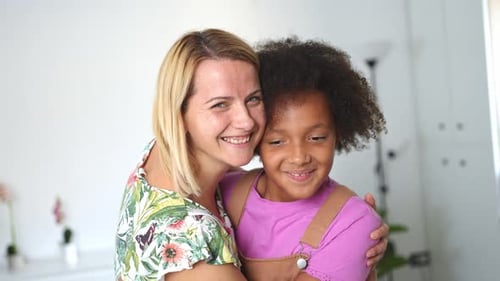 Affectionate Woman and Child Smiling Together in Home