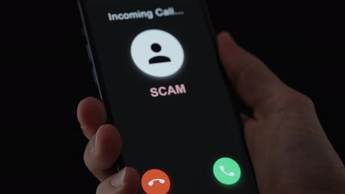 Hand Holding Phone Receiving Scam Call at Night