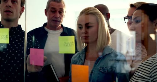 Group of Diverse Businesspeople Standing Together in a Modern Office Brainstorming With