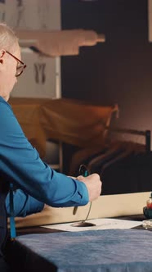 Vertical Video Tailor Choosing Items to Create Clothes