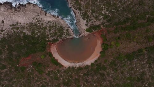 Aerial view of lagoon and cliff by the Mediterranean Sea, Greece.