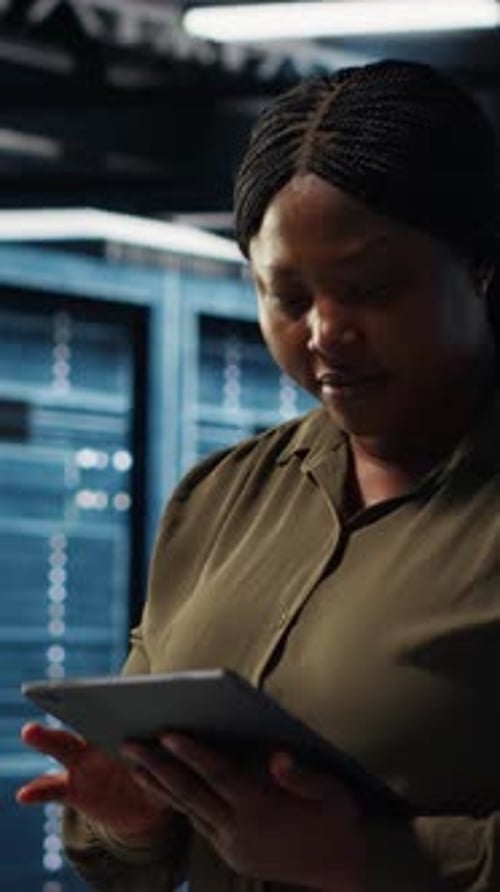 Woman Using Tablet in Data Center Server Room