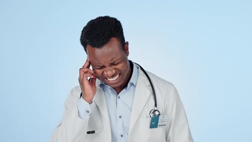 Black man, doctor and headache in stress, burnout or mistake against a studio background