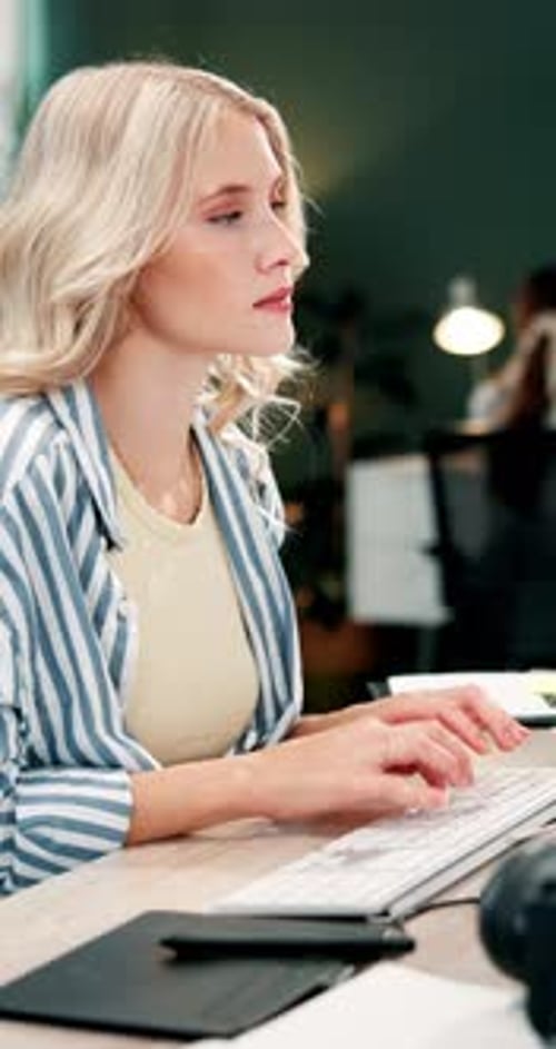 Business woman, computer and typing at agency for website design, brand identity or text layout
