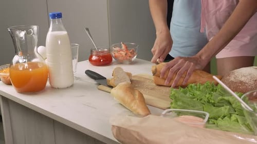 Close Up Cutting Bread in Kitchen