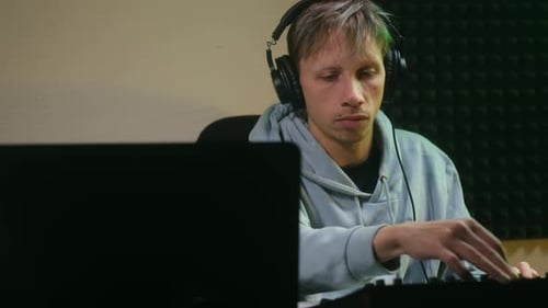 Young Musician Producing Music in a Soundproofed Recording Studio