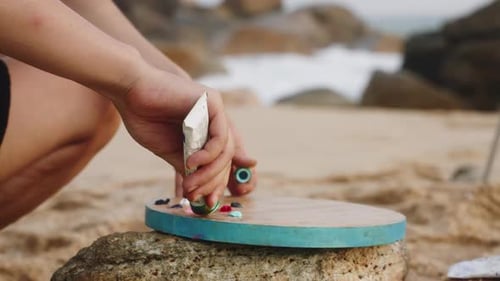 Artist Sets Up Color Palette on Sunny Seaside Creative Female Prepares Tools for Painting on Rocky