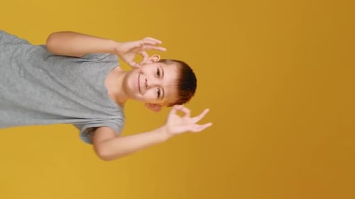 Boy Smiling and Making Okay Gesture