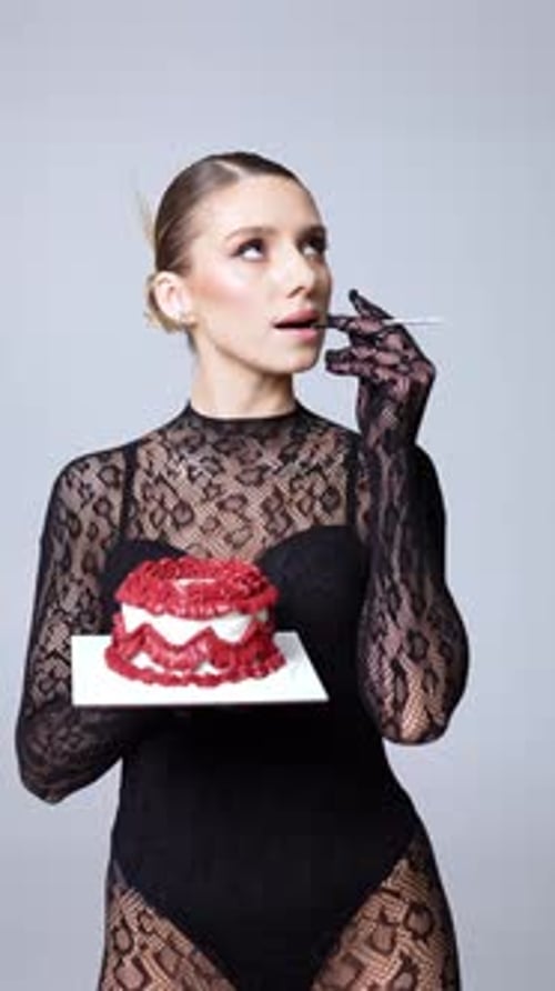 Woman Holds Red Velvet Cake in Studio