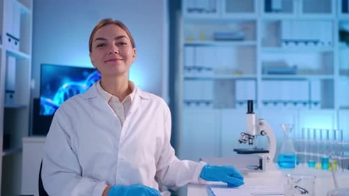 Female Scientist Smiling in a Modern Medical Laboratory