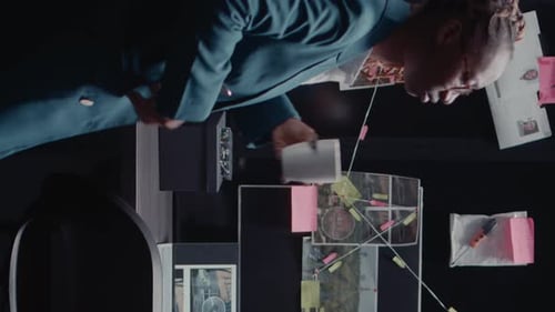 Woman Works at Desk Covered with Clues