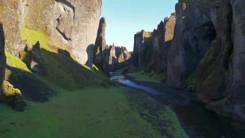 Drone Flying Close to the Narrow River in the Gorge of Fjadrargljufur Canyon