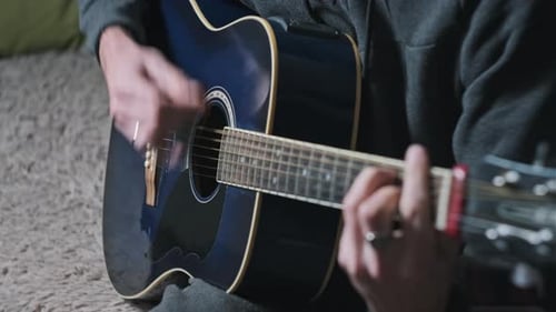 Person Plays Acoustic Guitar Close Up