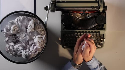 Writer Typing on Typewriter with Crumpled Paper, Birds Eye