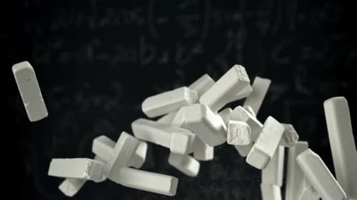 School Chalk Flies Against the Background of the Blackboard Filmed on a Highspeed Camera at 1000 Fps