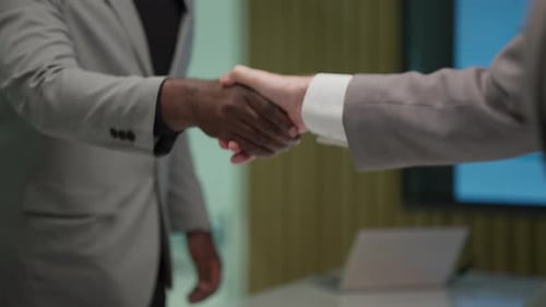 Business People Shaking Hands in Modern Office